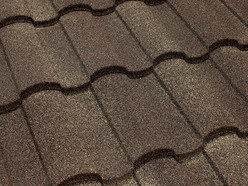 Close-up of Tilcor Antica stone-coated steel barrel-tile panel in Firenze terracotta